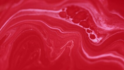 Ink fluid flow. Acrylic dye wave. Defocused red white color pigment liquid paint spill marble texture mix layers emulsion blend motion abstract art background.
