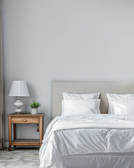 Modern hotel room with elegant bedding and stylish decor. Neutral tones and use of natural light.