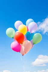 A bunch of colorful balloons are floating in the sky