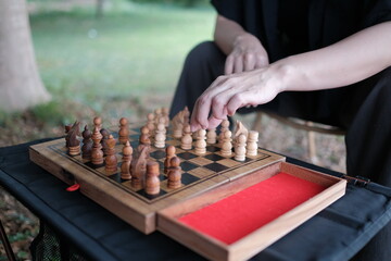 people playing chess and moving a piece, strategy chess game challenge competition play