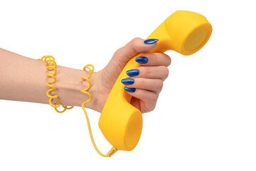 Yellow handset in woman hand isolated on white. Copy space.
