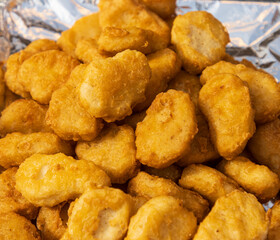 fried chicken nuggets as background.