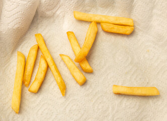 French fries on a paper towel. Close-up