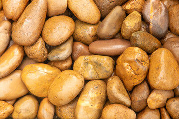Round stones in the wall as an abstract background. Texture
