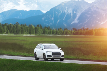 Fototapeta premium Luxury white SUV explores scenic route