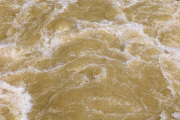 Churned up muddy brown water in the Lech after the 2024 flood of the century at Lake Mandicho