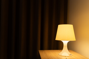 Lamp on table of bedside, Interior of the bedroom, warm light for background.