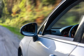 Car side mirror represents reflection, safety and the visual extension.