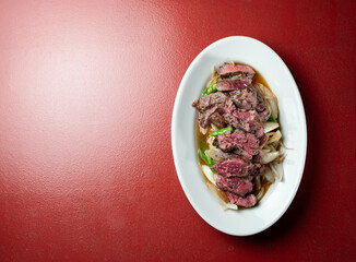 Meat tataki with vegetables on a plate
