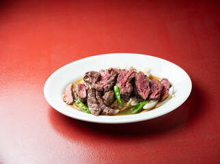 Meat tataki with vegetables on a plate