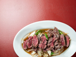 Meat tataki with vegetables on a plate