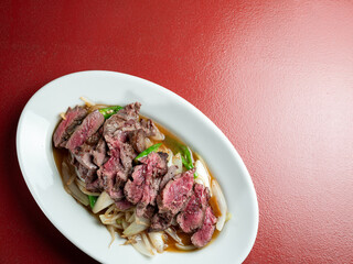 Meat tataki with vegetables on a plate
