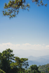 landscape and travel concept with solo freelancer man sit on wooden and use tablet work from outdoor with layer of mountain background