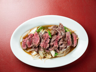 Meat tataki with vegetables on a plate	