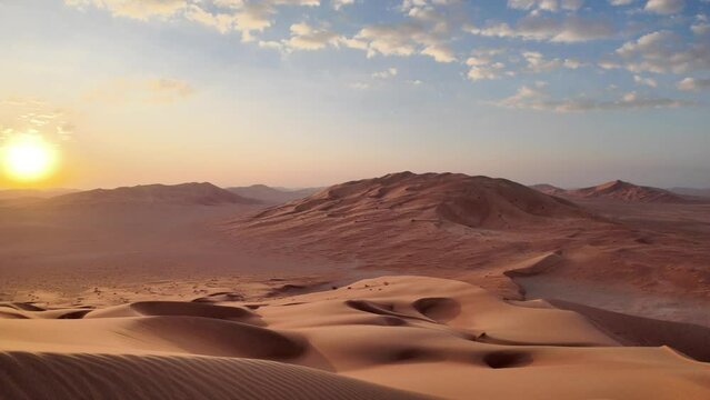 In the tranquil expanse of Oman's Empty Quarter, Rub' al-Khali desert paints a breathtaking panorama as the first light of dawn graces the horizon.