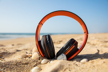orange headphones on beach