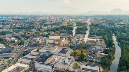 Ghent, Belgium. Factory with chimneys and clouds of smoke in the suburbs of Ghent. River Esco (Scheldt), Aerial View