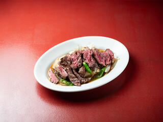 Meat tataki with vegetables on a plate	