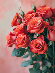 Fototapeta premium A bouquet of vibrant red roses against a soft pink background.