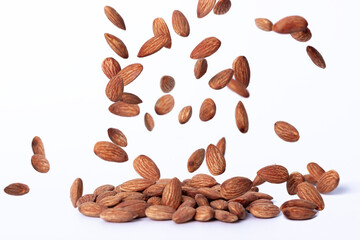 Almond snack fruit, Falling almond seeds scattered all over a white