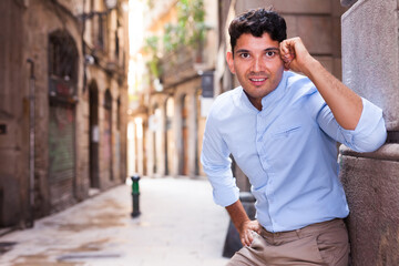 Smiling young guy on city street