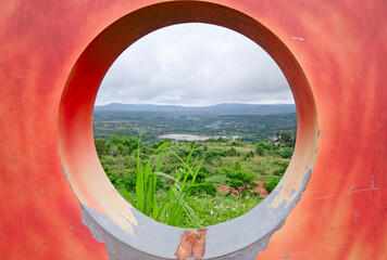 A scenic landscape through a circular frame, highlighting the natural beauty within the frame