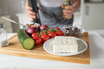 Greek salad with tuna ingredients on a cutting board