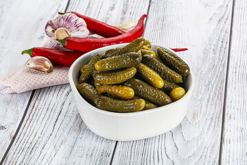 Marinated small cucumbers in the bowl