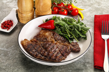 Grilled chuck roll steak with arugula