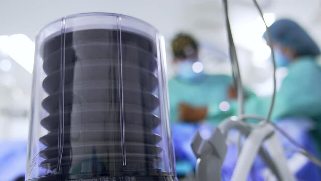Air is pumped to the patient undergoing surgery. Low angle view on the pump of lung ventilating machine. Close up.