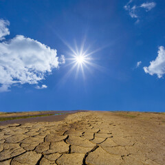 dry cracked earth under a sparkle sun