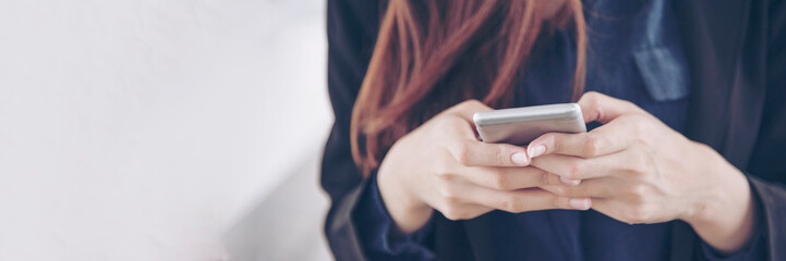 Banner Woman hands holding mobile phone outdoor surfing internet online technology lifestyle. Close up woman hand using smartphone gadget text message panoramic with copy space. Technology lifestyle