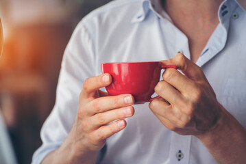 Close up hands of man sitting office desk holding sweet coffee cup relax and enjoy with happy time....