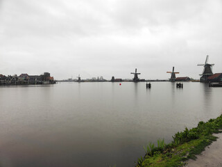 Fototapeta premium The Zaanse Schans windmills in rainy day