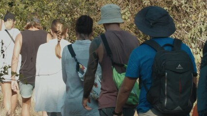 Hiking in the Komodo National Park. Group of tourists walk in the Komodo National Park in search of the Komodo dragons Varanus komodoensis in Indonesia