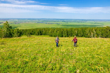 Fototapeta premium tourists men and women walk along the ridges of the Southern Urals on a summer day. Irendyk ridge