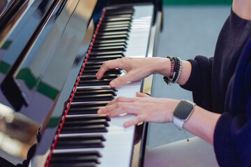 close up of a woman's hands playing the piano