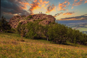 tourists men and women walk along the ridges of the Southern Urals on a summer day. Irendyk ridge
