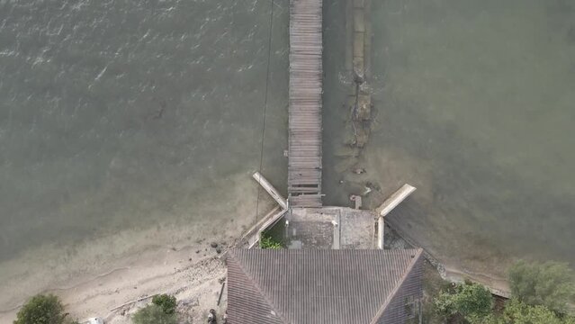 Aerial view of boats moored on a wooden pier. Dock at Beautiful Sea