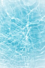 Blue water with ripples on the surface. Defocus blurred transparent blue colored clear calm water surface texture with splashes and bubbles. Water waves with shining pattern texture background.	