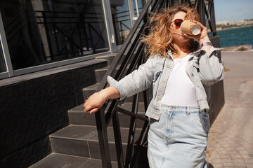 Plus size woman dressed jeans shirt, sunglasses, t-shert and skirt ealking in the street, Woman...