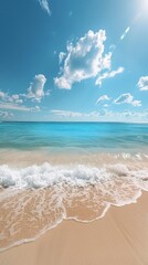 A sunny day at the beach. The sky is a clear blue with a few white clouds. The water is a bright turquoise color, and there are gentle waves rolling in towards the shore. The beach is covered in soft,