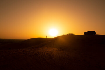 Ras Al Khaimah, United Arab Emirates - May 06, 2024: jeep safari in the desert at sunset