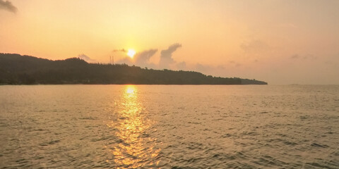 Fototapeta premium sea with blue sky and cloud background with wave. Mountain island over the sea.