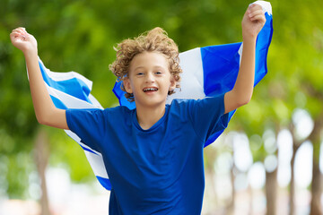 Child running with Scotland flag