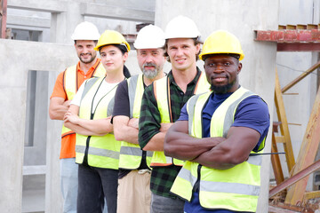 Engineer, industrial engineer standing smiling at work site.