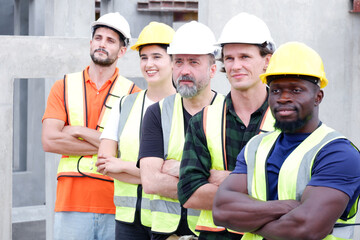 Engineer, industrial engineer standing smiling at work site.