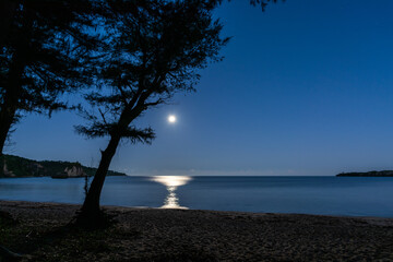 Serene moonset reflecting in the sea at the beach. Iriomote Island, Okinawa.