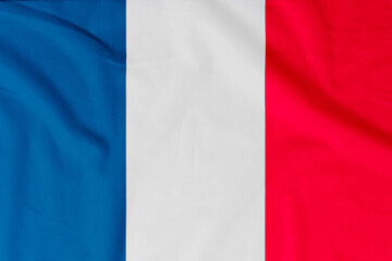 Flag of France (French Republic) with natural material creases as a background
