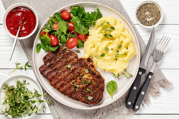 grilled pork steak with mashed potato and salad